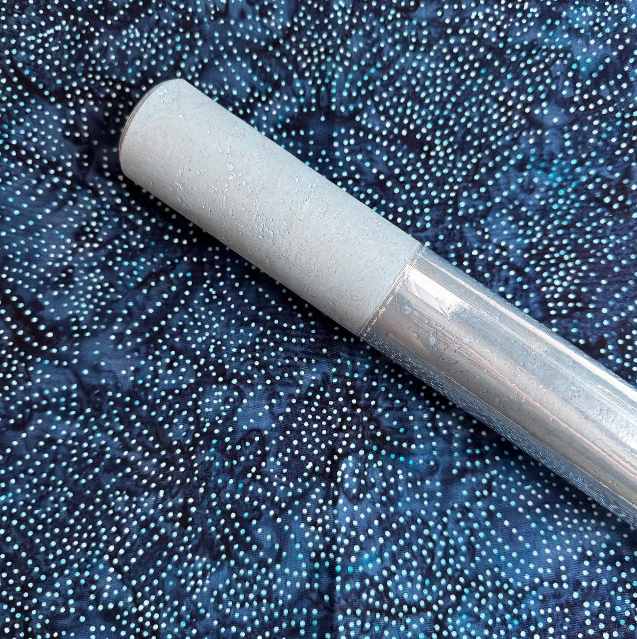 Powder blue cork fabric paired with navy blue batik cotton fabric featuring dotted floral patterns for sewing handbags, totes, wallets, and handmade accessories.