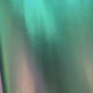 Video of high-quality iridescent green synthetic leather material with a smooth, reflective surface for bags