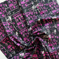 Fabric with a black and pink geometric pattern on a white background