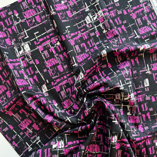 Fabric with a black and pink geometric pattern on a white background