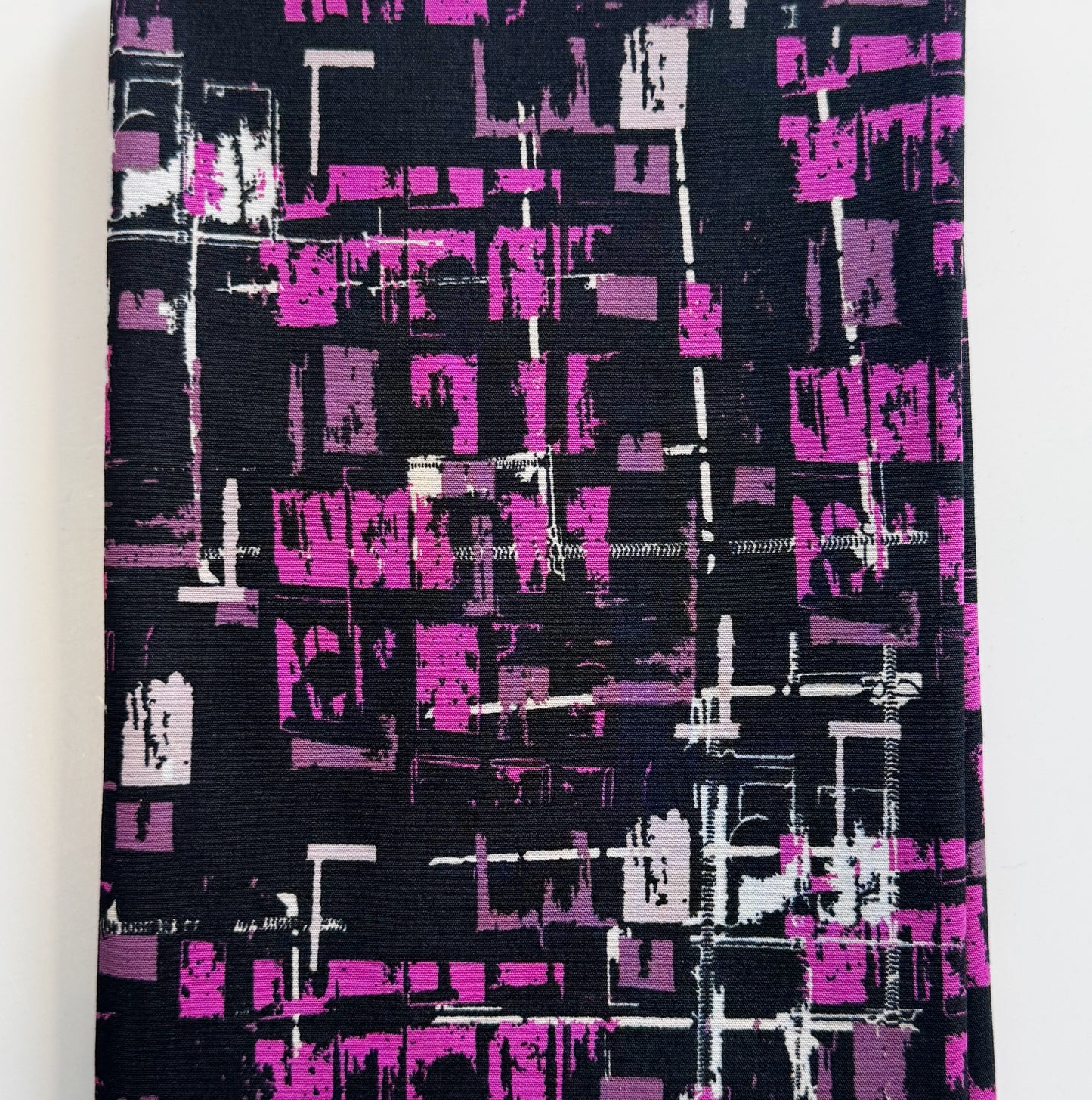 Fabric with abstract purple and white pattern on black background