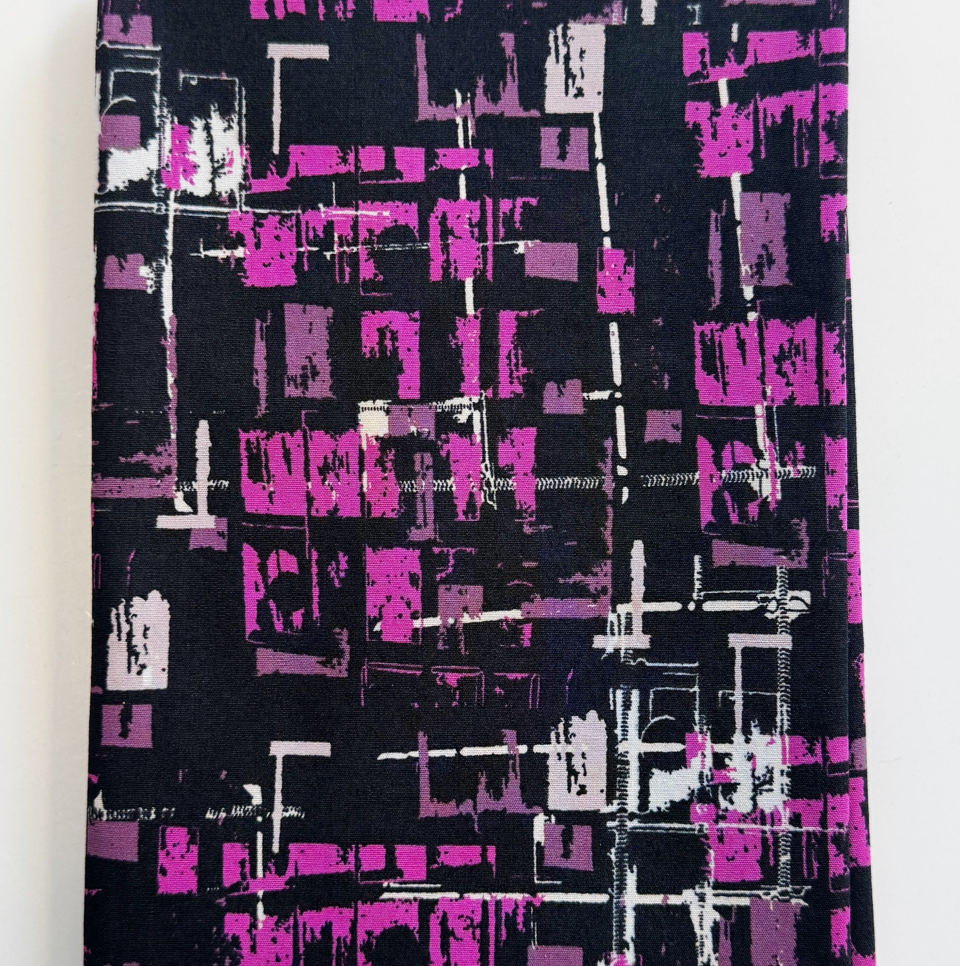 Fabric with abstract purple and white pattern on black background