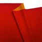 red faux leather or vinyl fabric with a smooth matte finish, featuring a diagonal fold that reveals a contrasting orange-gold underside against a white background