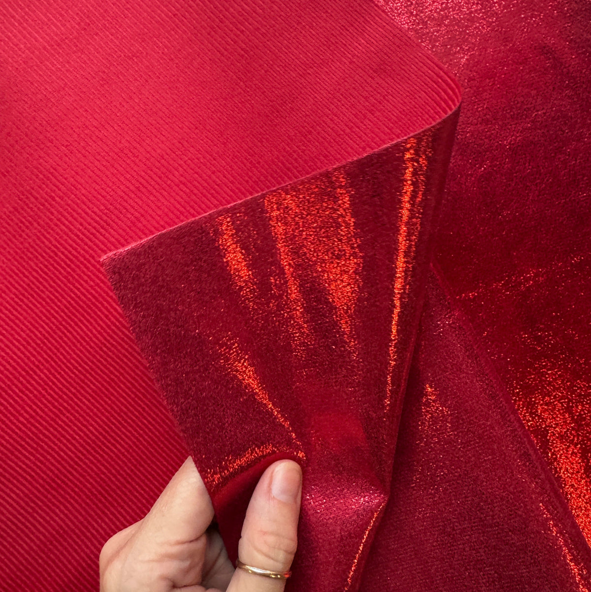Red metallic soft vinyl for bag making with textured red backing