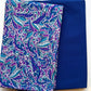 Folded quilting fabrics featuring a royal blue, purple, teal, and aqua leaf print paired with coordinating solid royal blue fabric