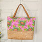 Santorini tote bag with pink floral pattern and woven base, hanging on a hook white door