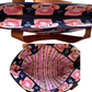 A tote bag shown from the front and back, featuring a navy blue exterior with a pink and orange retro rotary phone pattern, tan leather handles, and a pink striped interior.