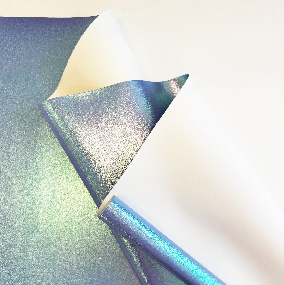 Holographic vinyl sheet with metallic sheen on a gradient background
