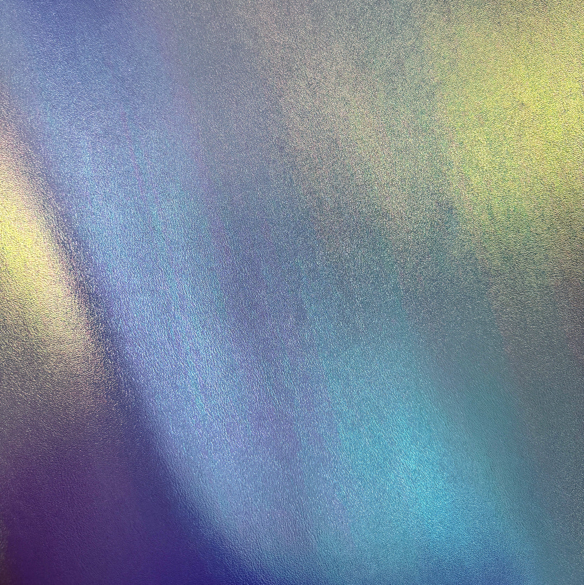 Gradient of blue, green, and purple colors on a textured surface