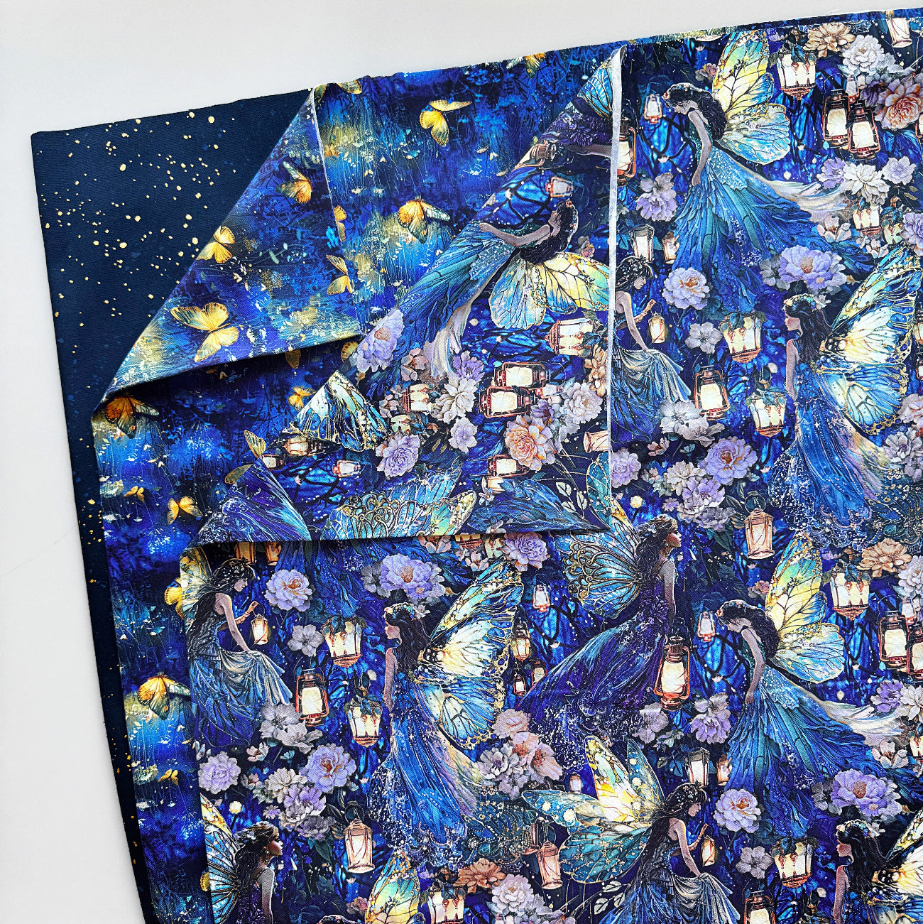 Blue fantasy fabric featuring fairies, butterflies, flowers and lanterns from Sew Hungry Hippie