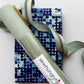 Blue geometric patterned fabric with mint green textured faux leather, webbing and zipper from Sew Hungry Hippie