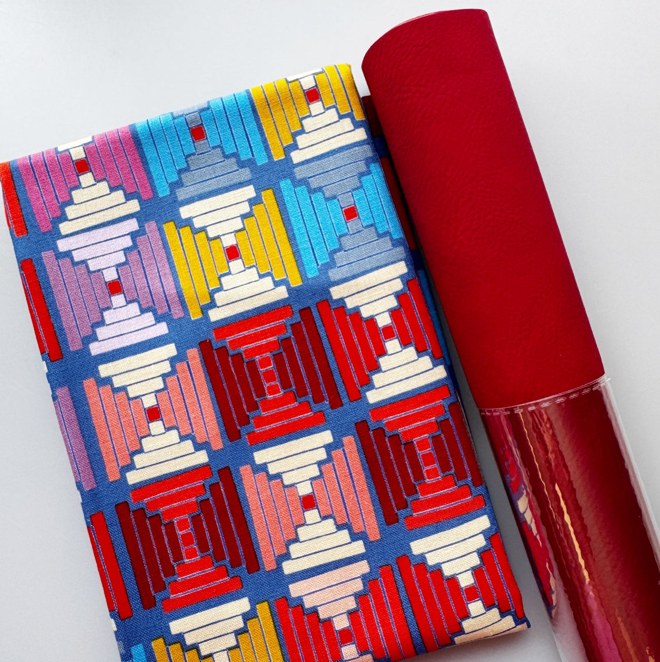 Blue geometric patterned fabric paired with red textured faux leather from Sew Hungry Hippie