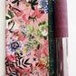 SewHungryHippie bag making kit featuring pink tropical hummingbird floral fabric, a dark green and gold metallic fabric coordinate, and a roll of burgundy cork fabric.