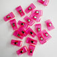 20 packs of translucent bright pink plastic sewing clips scattered on a white surface, commonly used for bag making and quilting.