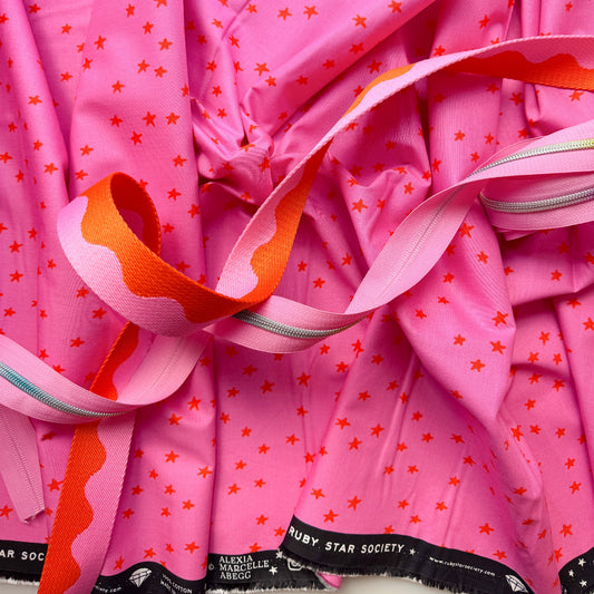 Pink star print fabric bundle with pink and orange webbing and silver zipper tape from Sew Hungry Hippie
