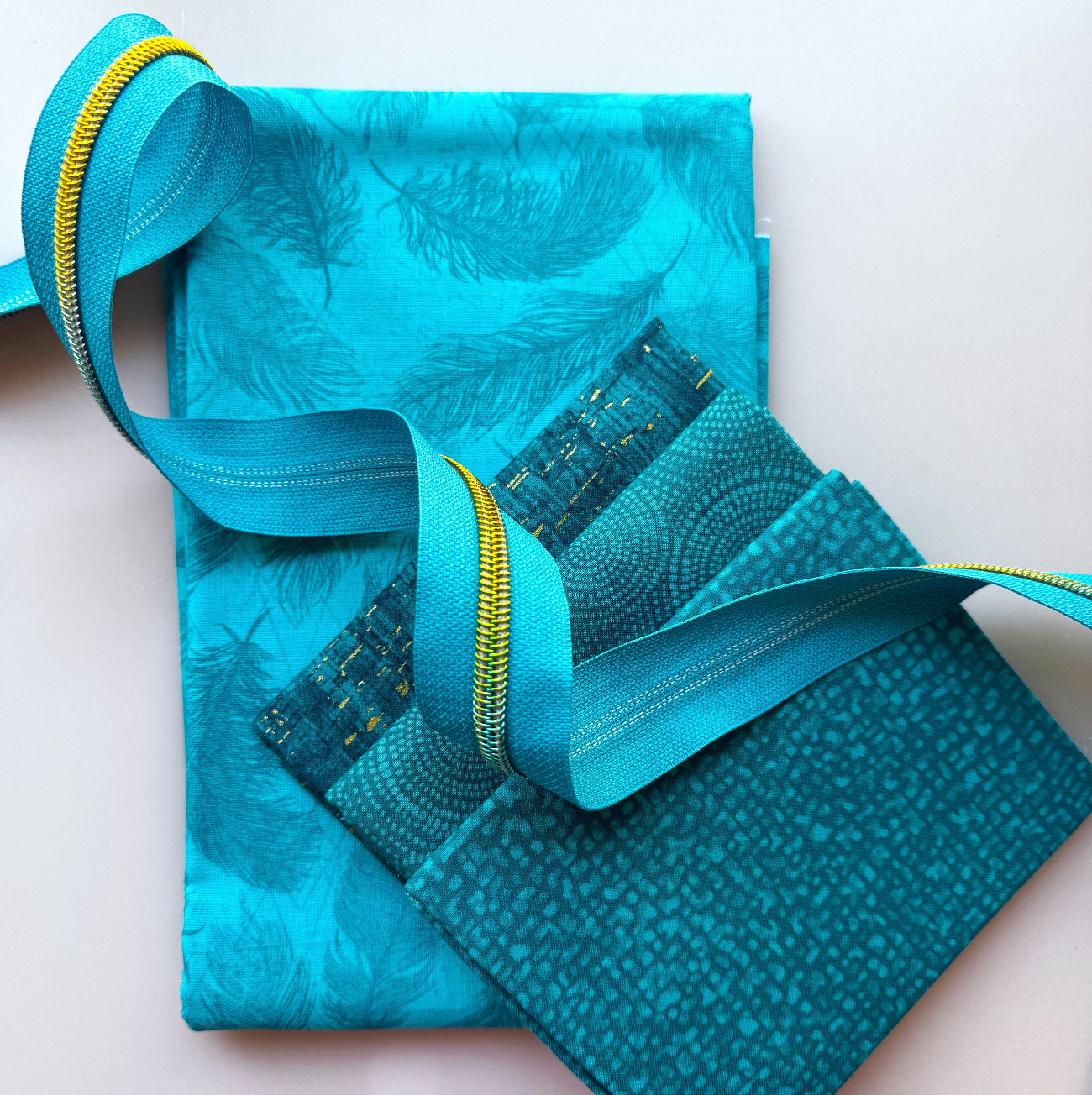 Teal blue fabric bundle with matching webbing, gold zipper and coordinating textured fabrics from Sew Hungry Hippie