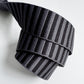 A 1.5-inch wide jacquard woven webbing strap featuring a charcoal grey and black horizontal stripe pattern, neatly coiled against a white background.