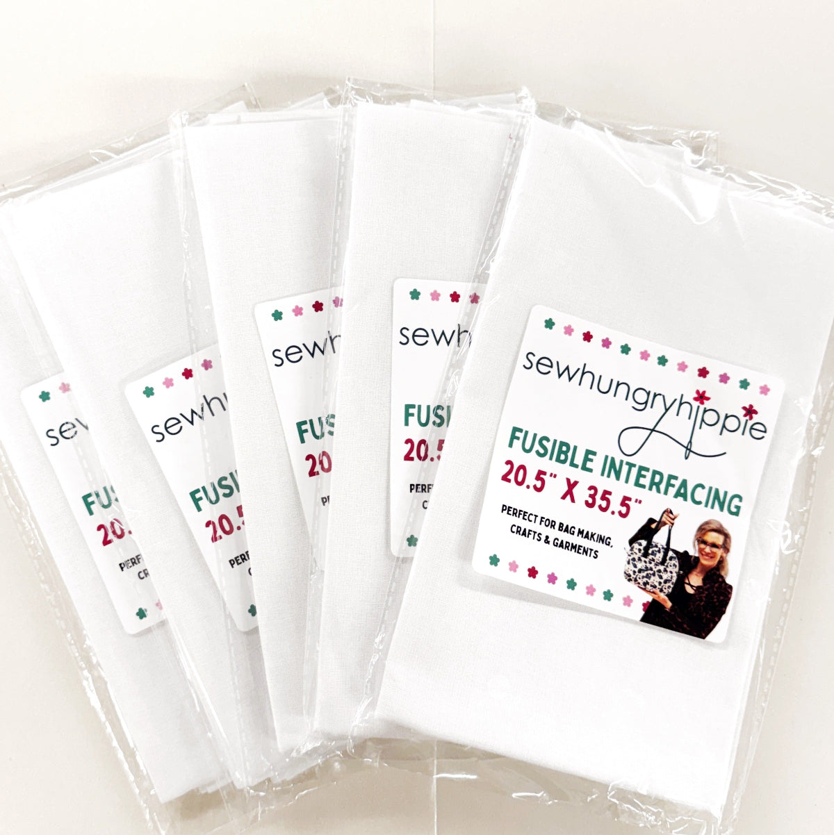 Multiple packages of fusible interfacing with visible branding on a white background