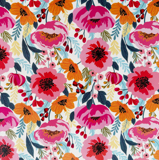 Closed up image of bright floral print vinyl fabric with bold poppy flowers in pink and orange tones designed for sewing, bag making, and crafting