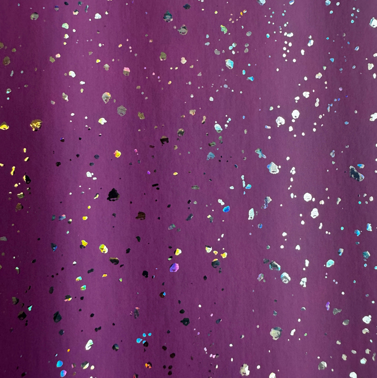 Purple glitter fabric with scattered iridescent holographic confetti dots.