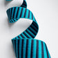 Teal and black striped webbing on a white background