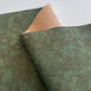 Green textured cork with a brown corner on a white background