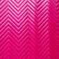 Bright pink chevron quilted fabric texture with stitched zigzag pattern.