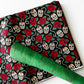 Fabric with skull and rose pattern on a white background