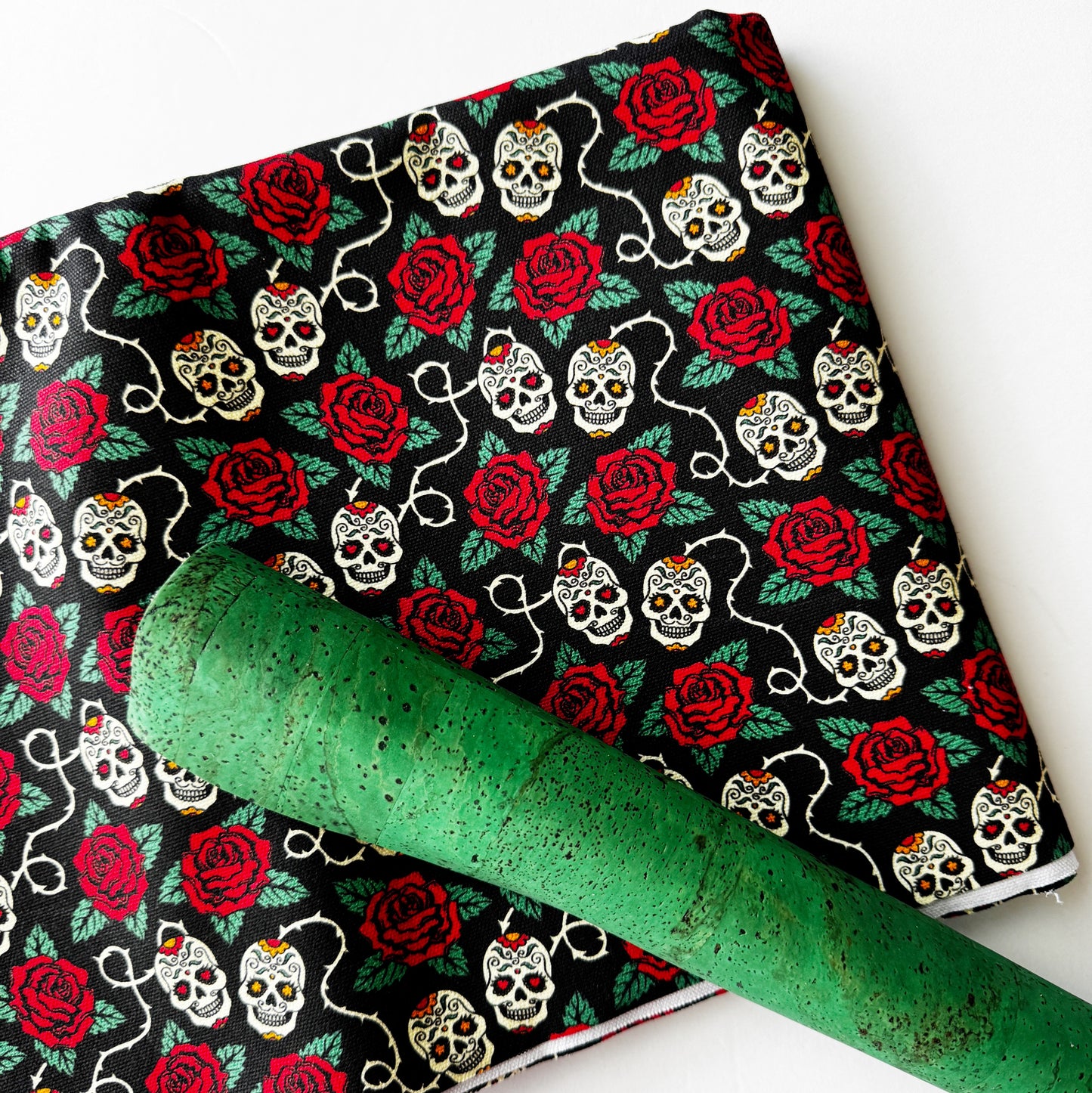 Fabric with skull and rose pattern on a white background