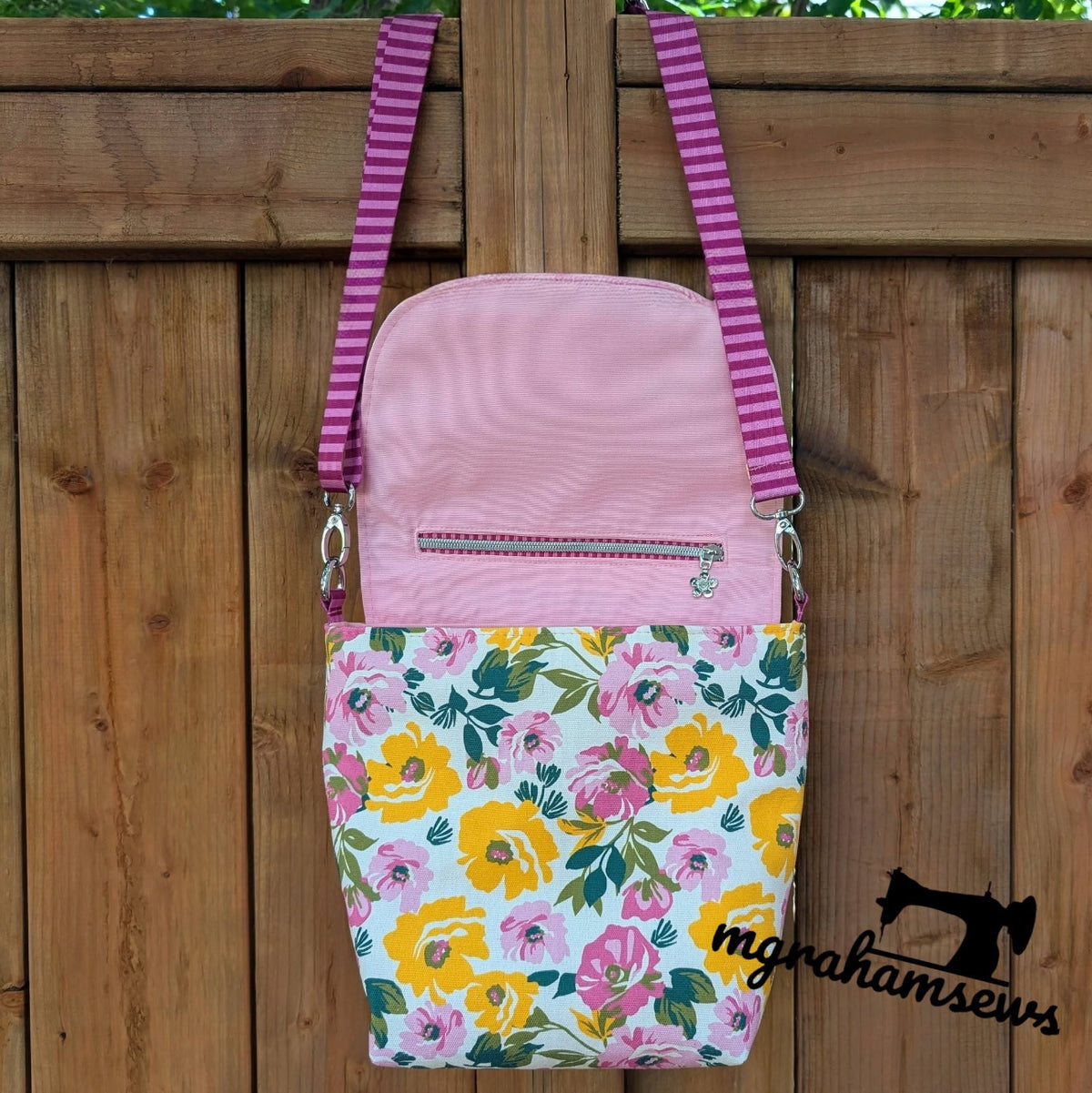 Iris Messenger Bag in vibrant floral canvas with a secret zipper pocket in the flap