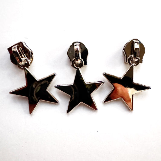 Three star-shaped zipper pulls zipper heads on a white background
