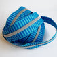 Blue striped zipper with silver teeth on a white background