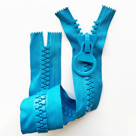A blue zipper tape, shown in multiple pieces folded together on a plain white background.