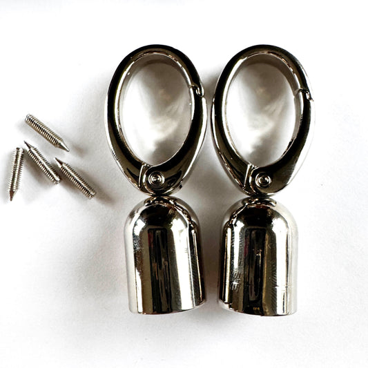 Pair of metallic tassel caps with screws on a white background