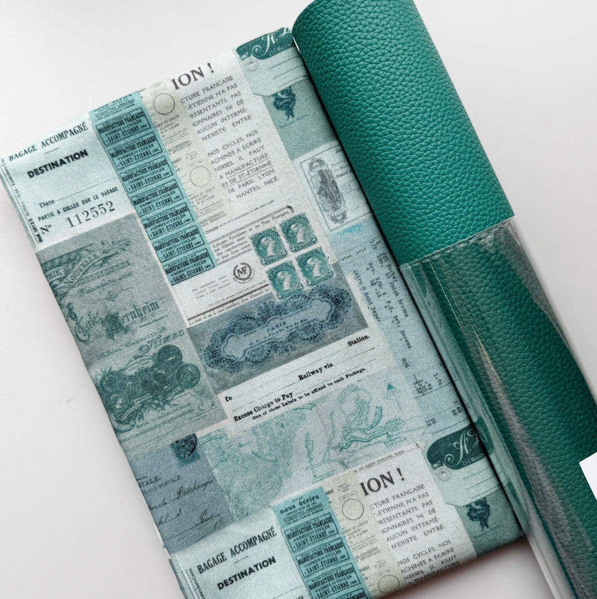 Teal travel ticket print fabric paired with textured teal faux leather for a handmade bag project.