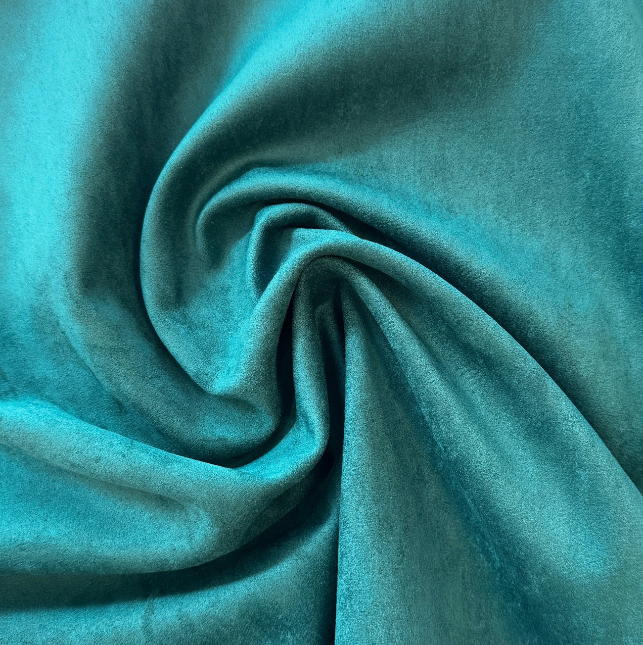 Close-up of teal fabric with folds