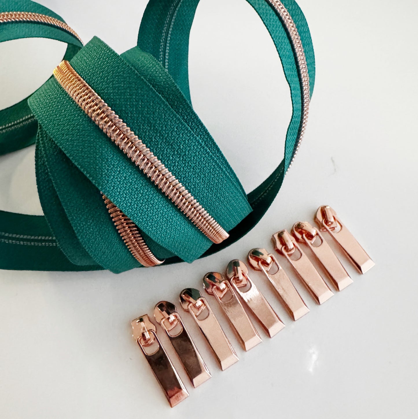 Green zipper with rose gold teeth and pulls