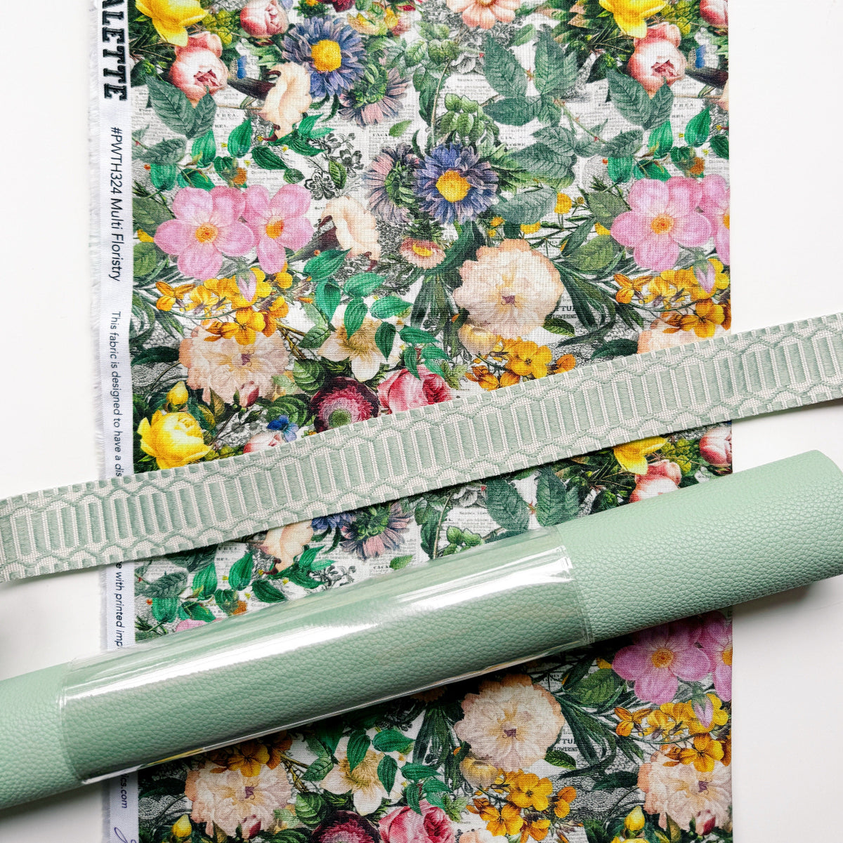 Multi Floristry cotton fabric from the Tim Holtz Palette Collection by FreeSpirit Fabrics, roll of sage green vinyl, and a 3 yards of coordinating sage green webbing