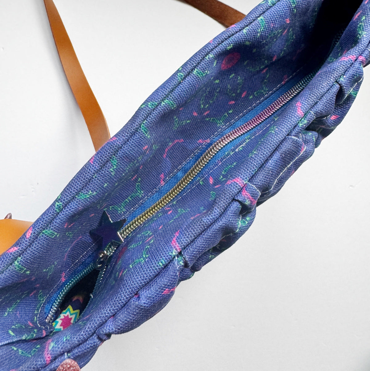Blue patterned bag with a star design on a white background