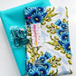 Turquoise faux leather paired with coordinating blue floral cotton fabric and teal bag hardware, perfect for handbags, totes, backpacks, wallets, crossbody bags, and sewing projects.