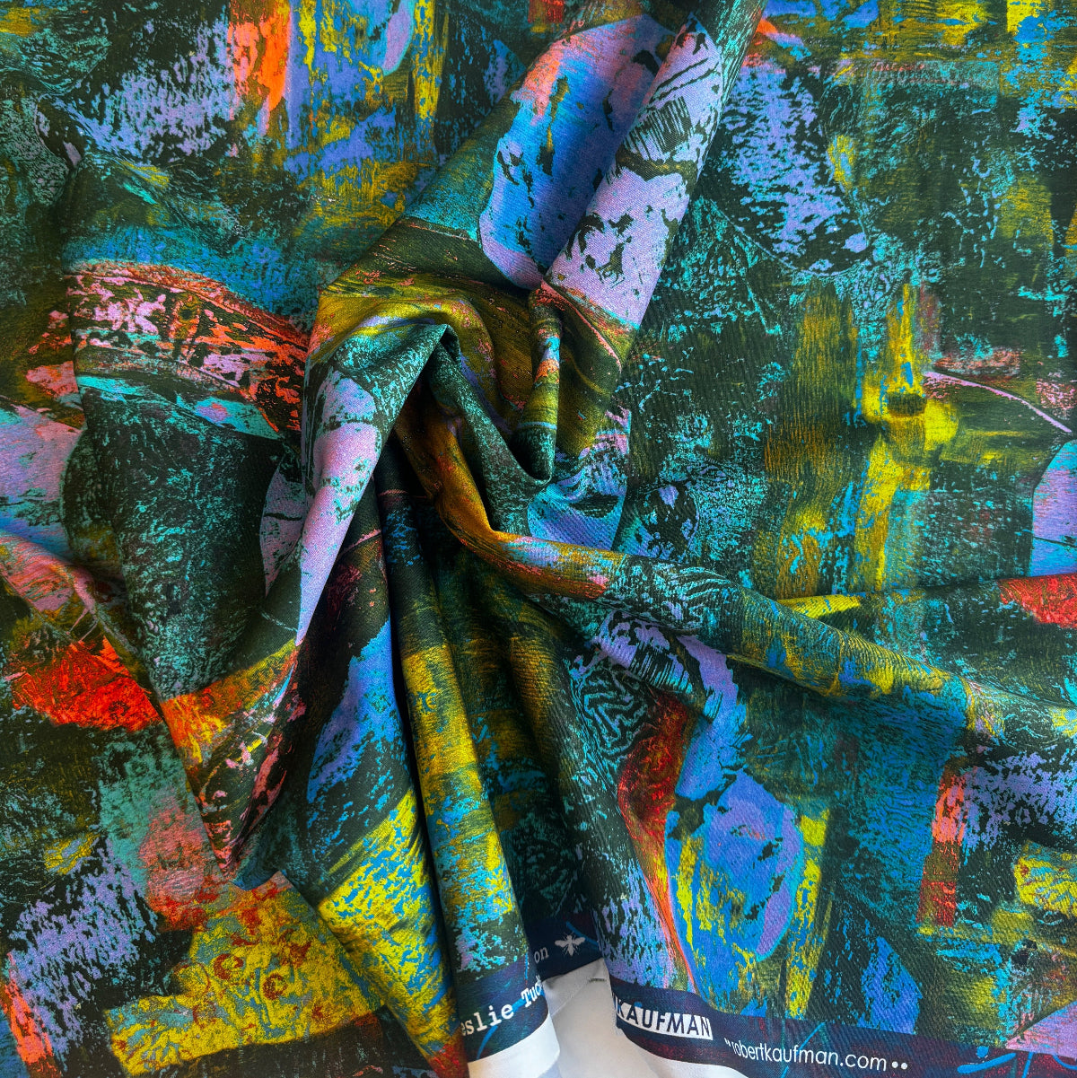 Colorful abstract fabric with a brand label on a textured background
