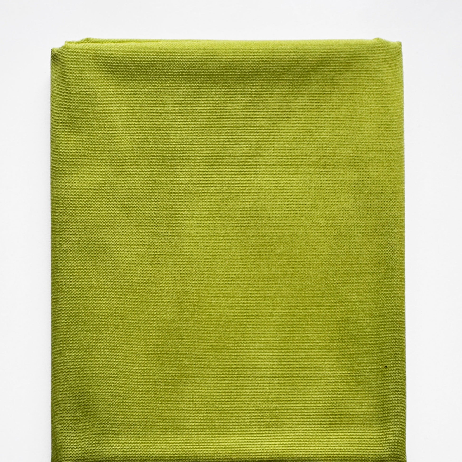 Folded green fabric on a white background