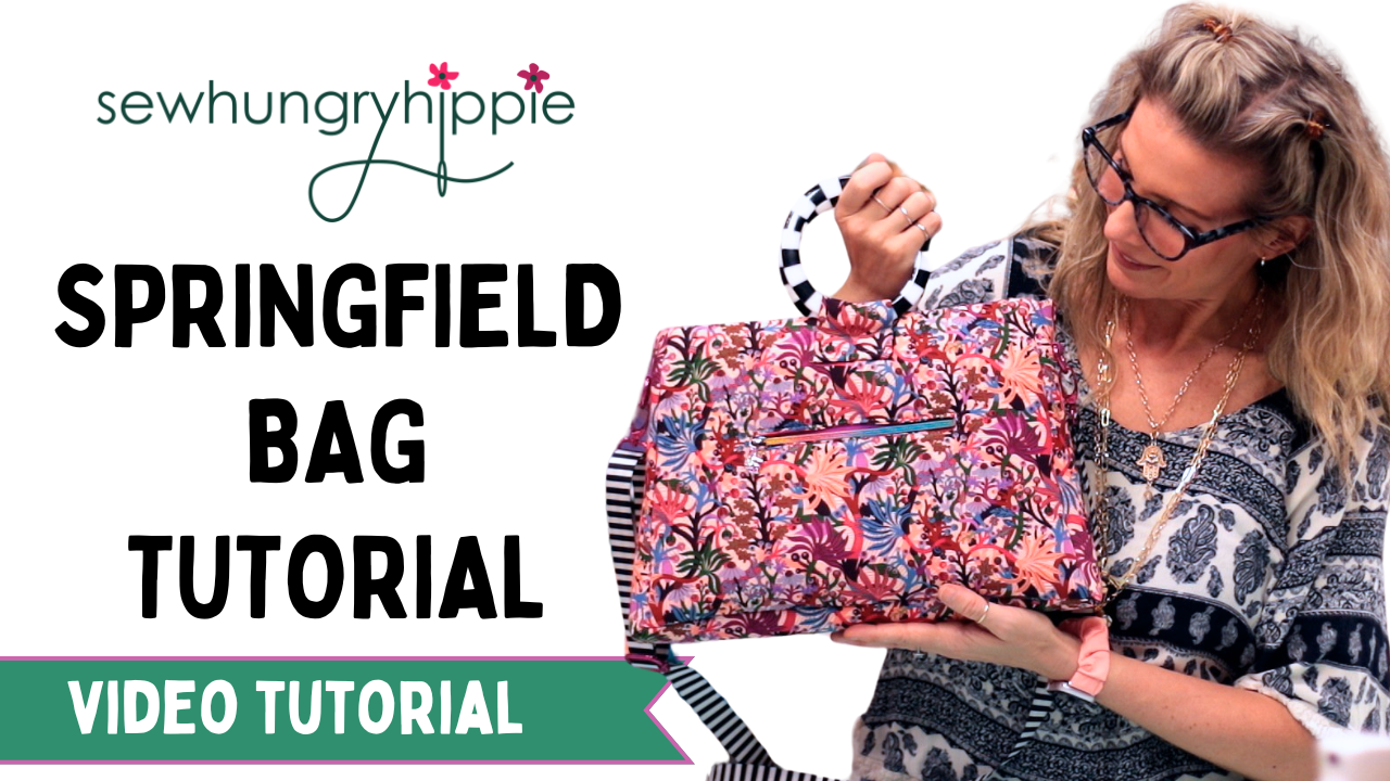 A woman wearing glasses and a patterned top holds up a colorful floral Springfield bag, with large text reading 'SEWHUNGRHYIPPIE SPRINGFIELD BAG TUTORIAL VIDEO TUTORIAL' on a white background.