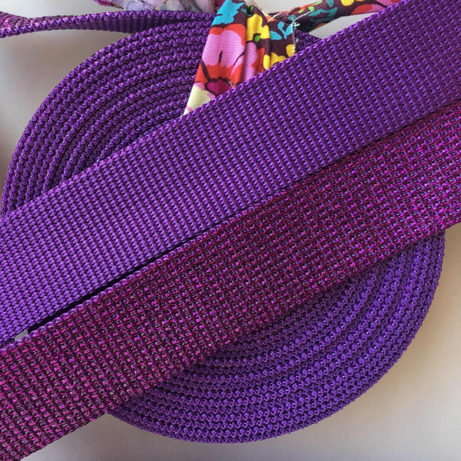 Purple fabric straps and coiled tape.