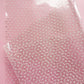 Clear plastic sheet with white polka dots.