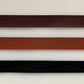 Leather belt samples in brown, tan, and black