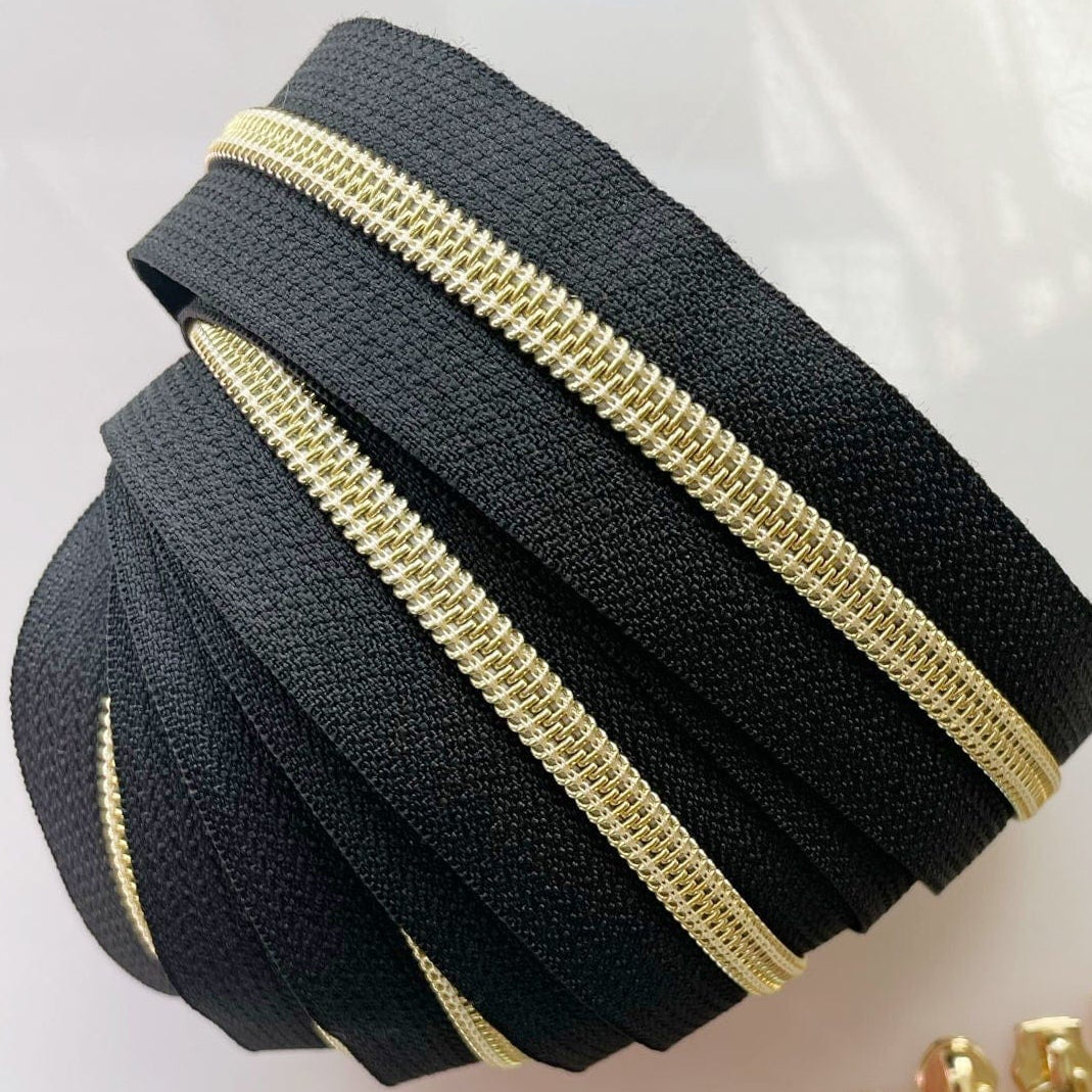 Black and gold zipper tape and zipper pulls.