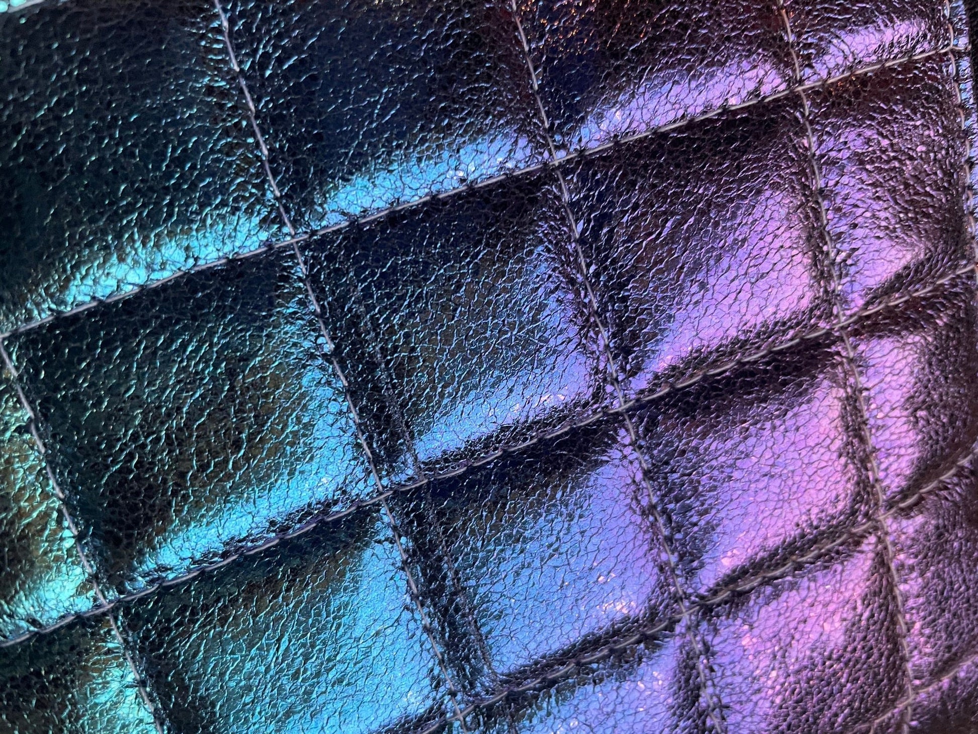Quilted, iridescent faux leather texture.