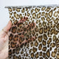 Hand holding leopard print vinyl sheet