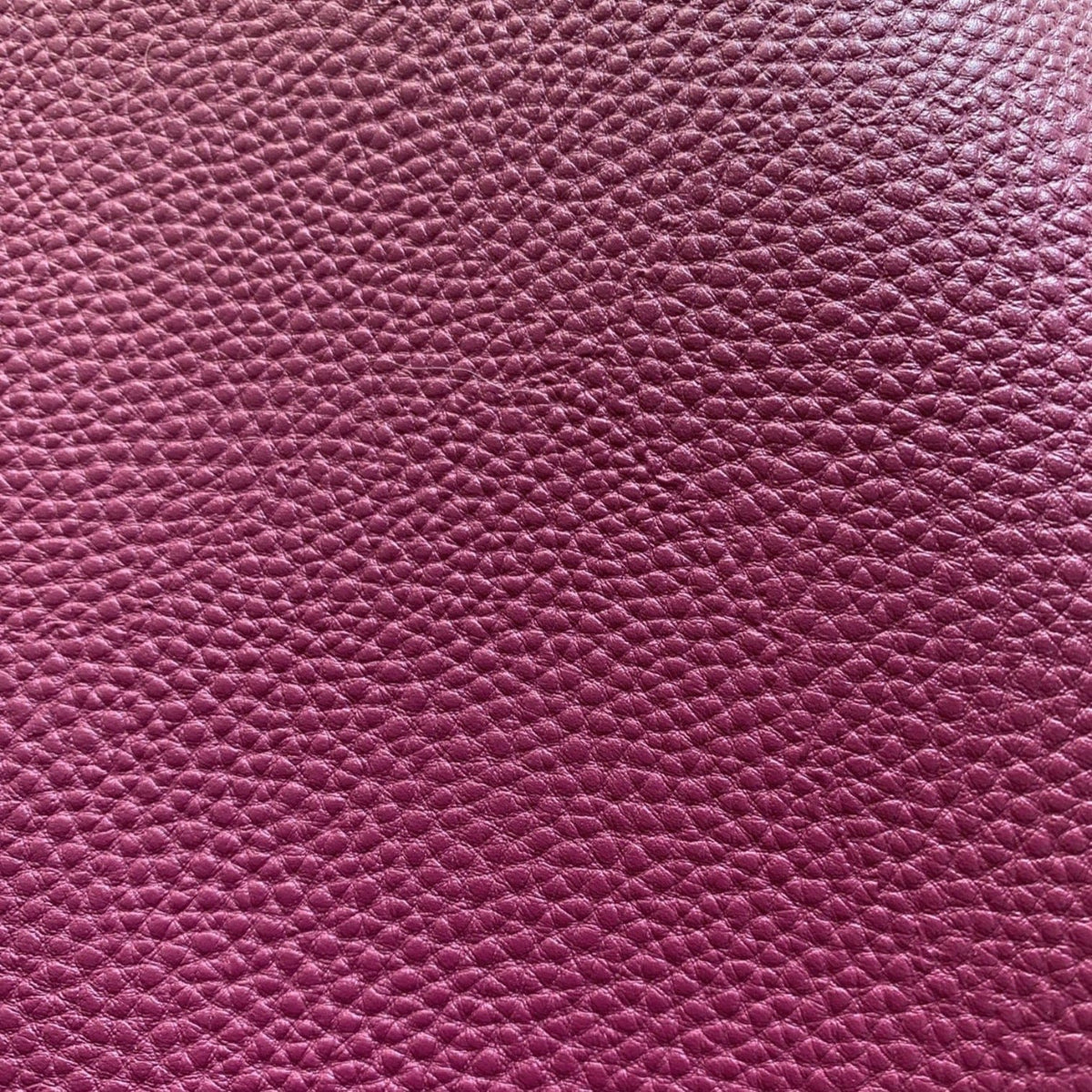 Magenta plum pebbled faux leather vinyl fabric with fine litchi grain texture